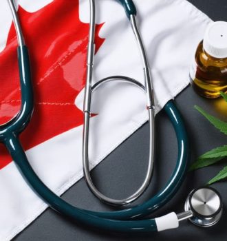 A stethoscope lying over the Canadian flag, with CBD oil bottles in the foreground, illustrating the intersection of medicine, Canadian regulations, and CBD treatments for healthcare providers.